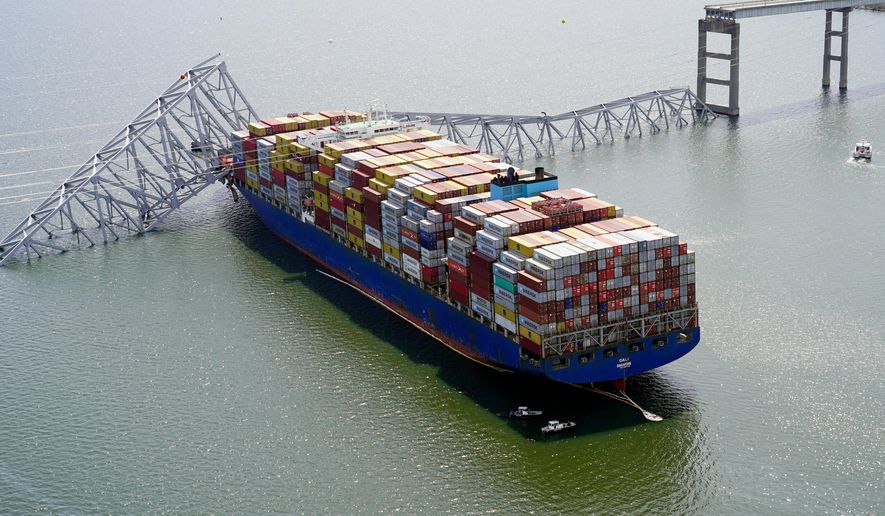 FILE - In this photo provided by the Maryland National Guard, the cargo ship Dali is stuck under part of the structure of the Francis Scott Key Bridge after the ship hit the bridge March 26, 2024, in Baltimore. (Maryland National Guard via AP, File)