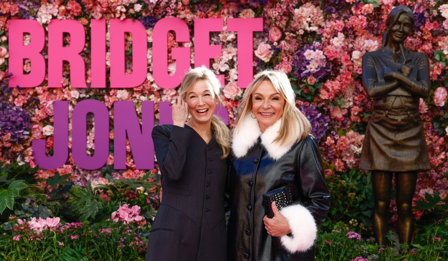 Renee Zellweger, left, and writer Helen Fielding pose for photographers during the unveiling of the Bridget Jones statue in Leicester Square, London, Monday, Nov. 17, 2025. (Photo by Millie Turner/Invision/AP)