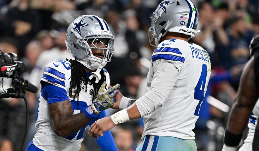 Dallas Cowboys wide receiver CeeDee Lamb, left, celebrates his touchdown against the Las Vegas Raiders with Cowboys quarterback Dak Prescott (4) during the first half of an NFL football game Monday, Nov. 17, 2025, in Las Vegas. (AP Photo/David Becker)