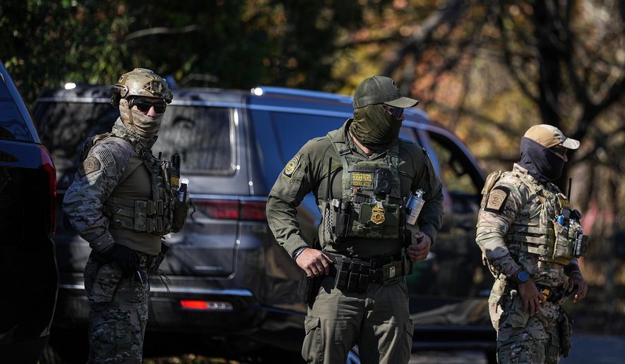 U.S. Border Patrol agents look on, Monday, Nov. 17, 2025, in Charlotte, N.C. (AP Photo/Matt Kelley)