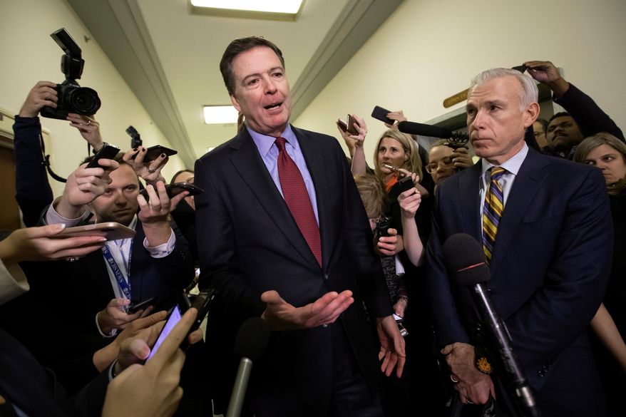 Former FBI Director James Comey, with his attorney, David Kelley, right, speaks to reporters after a day of testimony before the House Judiciary and Oversight committees, on Capitol Hill in Washington, Dec. 7, 2018. (AP Photo/J. Scott Applewhite, File)
