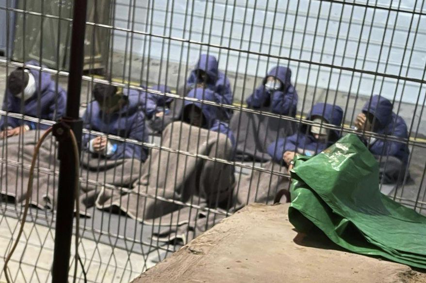 This 2024 photo provided by Breaking The Silence, a whistleblower group of former Israeli soldiers, shows prisoners with their hands and legs restrained in the yard at the Sde Teiman military prison in southern Israel. (Breaking The Silence via AP)