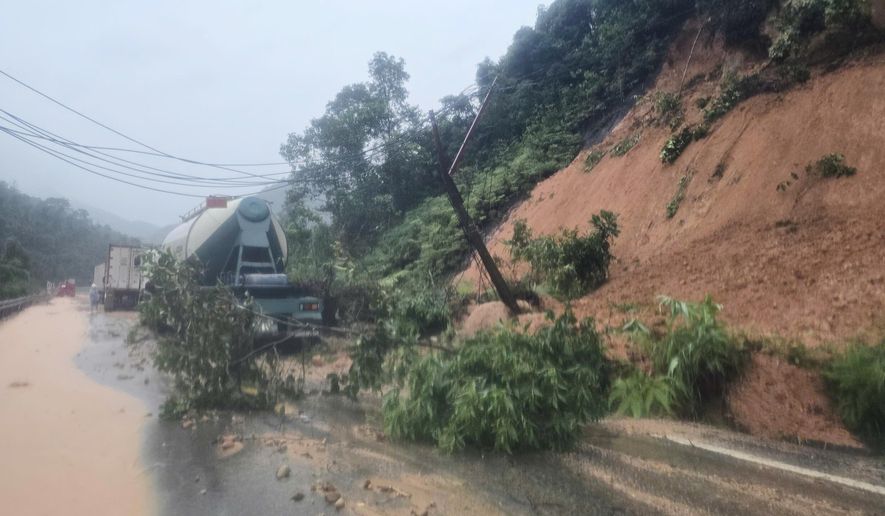 Landslides block the road on Khanh Le pass, near the location where a passenger bus was buried by a landslide in Khanh Hoa, Vietnam, Monday, Nov. 17, 2025. (Dang Tuan/VNA via AP)