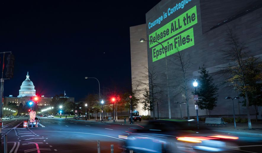 A World Without Exploitation projection is seen on the wall of the National Gallery of Art calling on Congress to vote yes on the Epstein files transparency act in Washington, Monday, Nov. 17, 2025. (AP Photo/Jose Luis Magana)