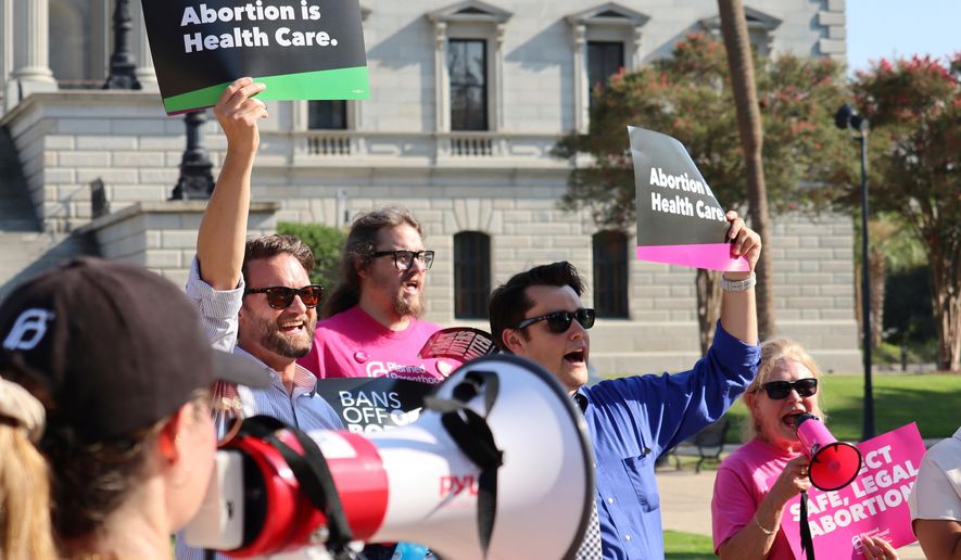 FILE - Over two dozen abortion rights supporters attend a rally outside the South Carolina State House in Columbia, S.C., on Aug. 23, 2023. (AP Photo/James Pollard, file)