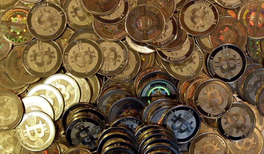 FILE - Bitcoin tokens are seen on April 3, 2013, in Sandy, Utah. (AP Photo/Rick Bowmer, File)