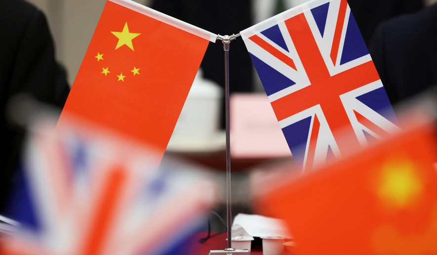 Flags of China and the Union Jack stand during the China-U.K. Energy Dialogue in Beijing, China, March 17, 2025. (Florence Lo/Pool Photo via AP, file)