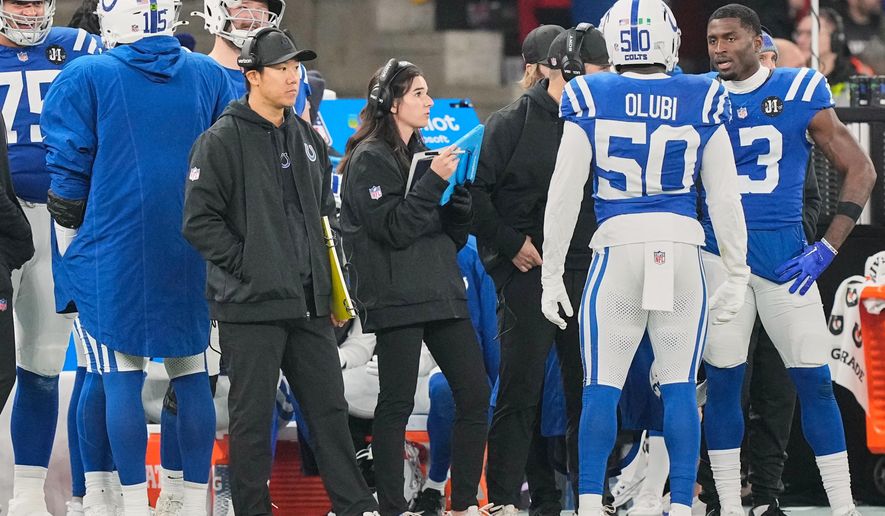 Indianapolis Colts assistant coach Isabel Diaz stands on the sideline during an NFL football game between the Indianapolis Colts and the Atlanta Falcons, Sunday, Nov. 9, 2025, in Berlin, Germany. (AP Photo/Martin Meissner)
