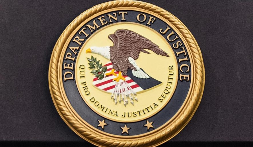 FILE - The Department of Justice logo is seen on a podium during a press conference at the U.S. Attorney's Office, Oct. 23, 2025, in New York. (AP Photo/Angelina Katsanis, File)