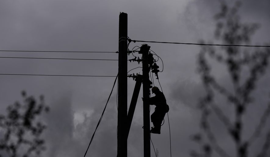 A worker climbs a utility pole while repairing power lines damaged by a Russian attack, Thursday, Oct. 16, 2025, in Shostka, Ukraine. (AP Photo/Julia Demaree Nikhinson)