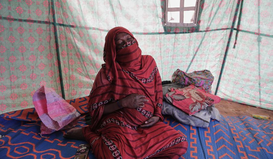 Nadra Mohamed Ahmed, 21, reacts during an interview with The Associated Press inside her tent at the newly established El-Afadh camp in Al Dabbah, Sudan's northern state, Monday, Nov. 17, 2025. (AP Photo/Marwan Ali)