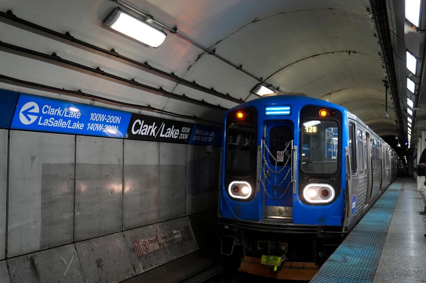 A train pulls into the Clark Street and Lake Street Blue Line stop where a man doused a woman in liquid and set her on fire on the train Monday night, Tuesday, Nov. 18, 2025, in Chicago. (AP Photo/Erin Hooley)
