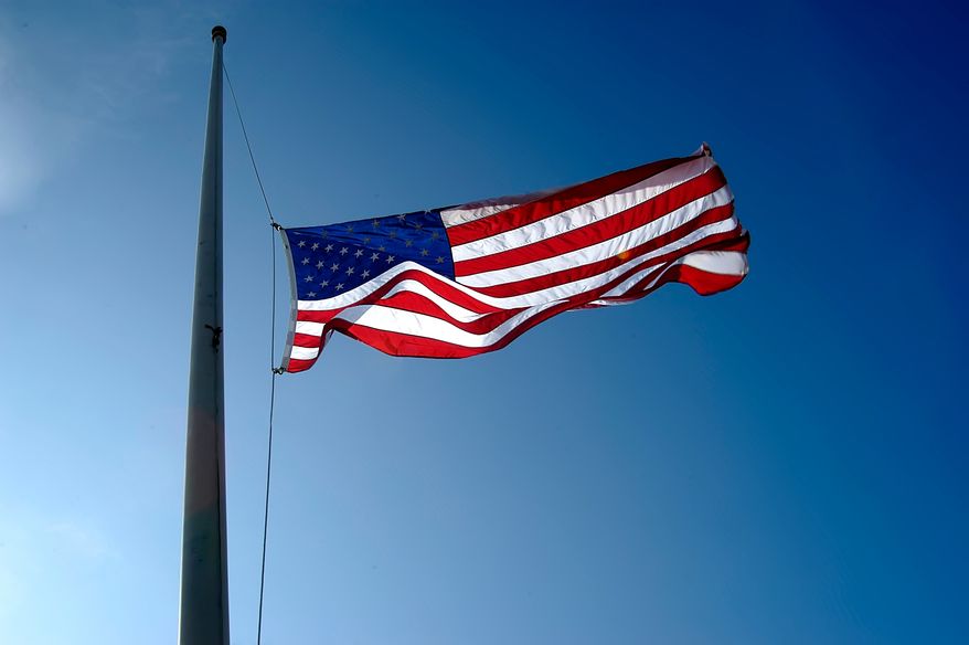 U.S. flag flies at half-staff. File photo credit: Dennis MacDonald via Shutterstock.