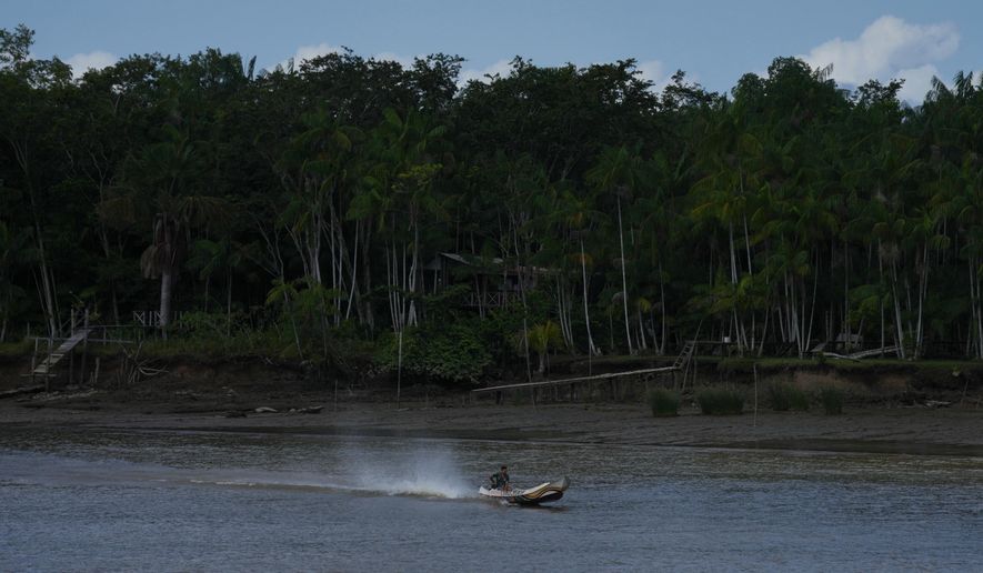 A boat maneuvers near the shore of Barcarena, Brazil, on Sunday, Nov. 9, 2025. (AP Photo/Fernando Llano)