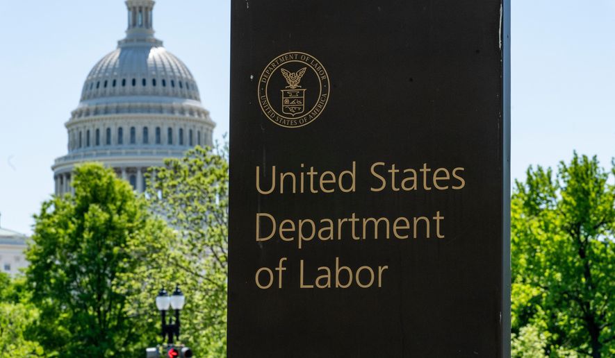 In this May 7, 2020, file photo, the entrance to the Labor Department is seen near the Capitol in Washington. (AP Photo/J. Scott Applewhite, File)