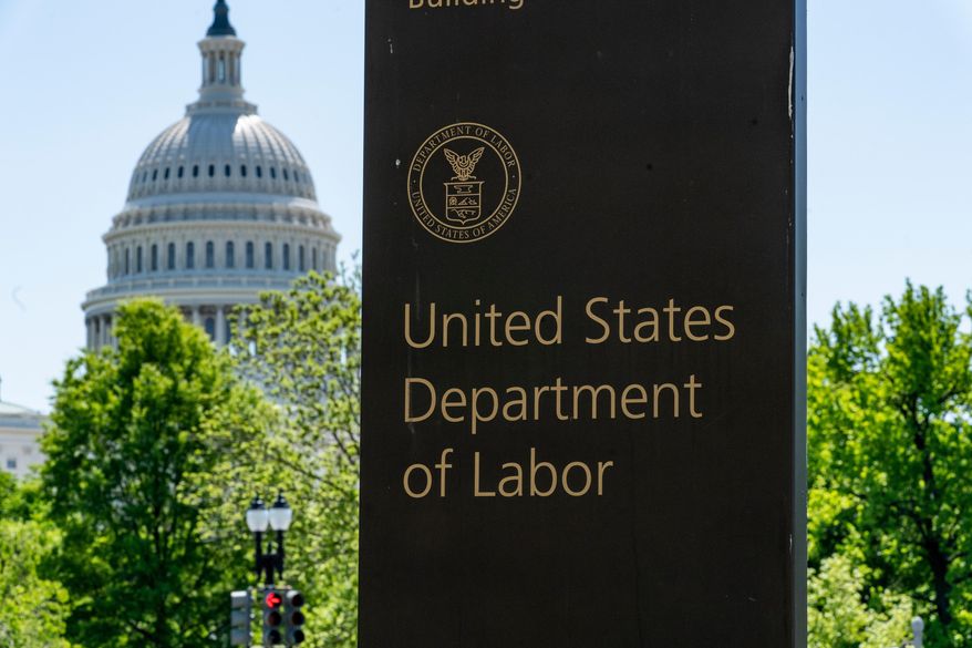 In this May 7, 2020, file photo, the entrance to the Labor Department is seen near the Capitol in Washington. (AP Photo/J. Scott Applewhite, File)