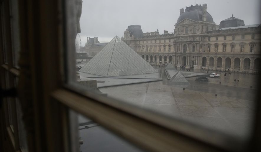The courtyard and the pyramid of Le Louvre museum are seen Wednesday, Nov. 19, 2025 in Paris. (AP Photo/Christophe Ena)