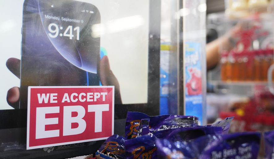 A sign is displayed for EBT for the USDA Supplemental Nutrition Assistance Program (SNAP) at the Friend's Meat Market and Grocery, Friday, Nov. 14, 2025, in Miami. (AP Photo/Lynne Sladky)