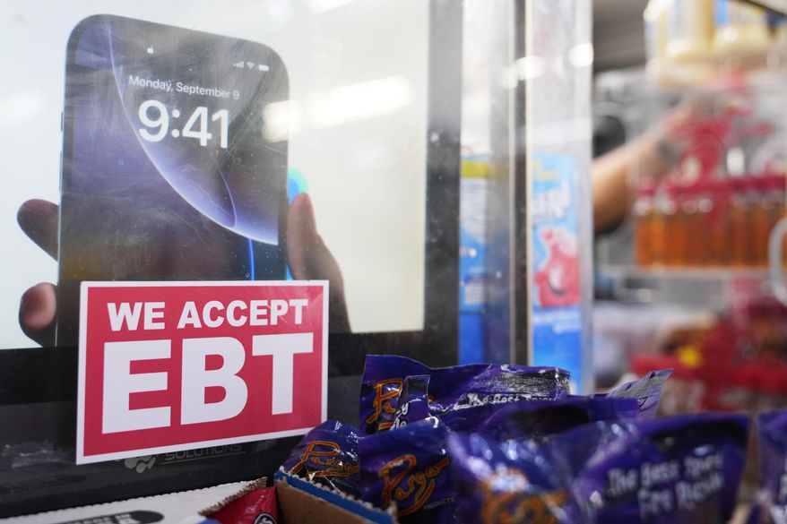 A sign is displayed for EBT for the USDA Supplemental Nutrition Assistance Program (SNAP) at the Friend's Meat Market and Grocery, Friday, Nov. 14, 2025, in Miami. (AP Photo/Lynne Sladky)
