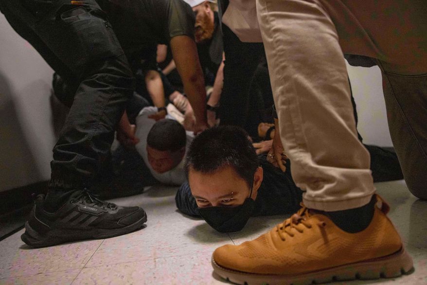 A Dominican man, left, and an activist, right, are detained by plainclothes officers with Immigration and Customs Enforcement after an immigration hearing at the immigration court inside the Jacob K. Javits Federal Building in New York, on June 6, 2025. (AP Photo/Yuki Iwamura, File)
