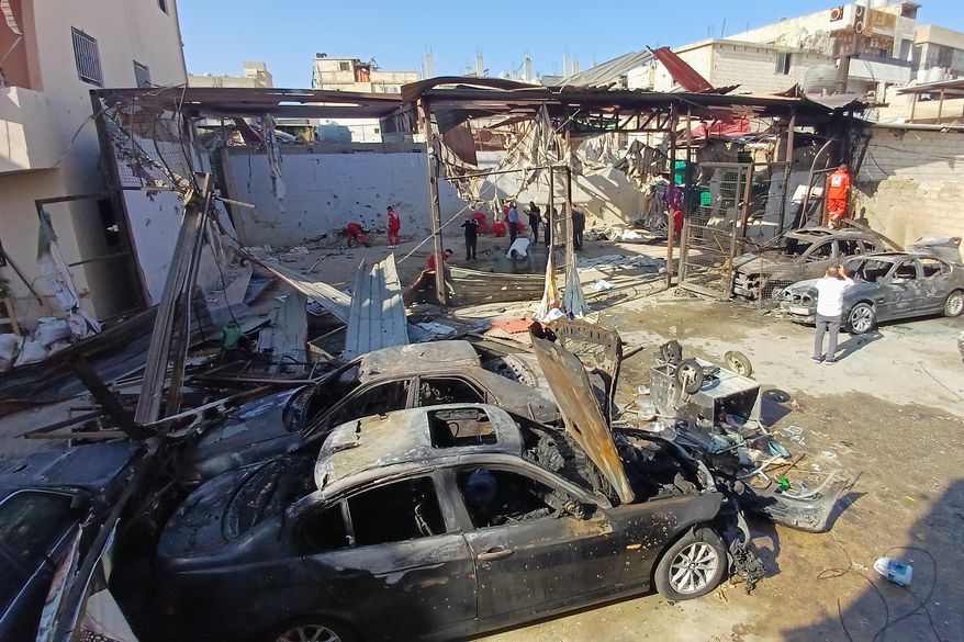 Palestinian rescue workers check the scene where an Israeli strike on Tuesday night hit the Ein el-Hilweh Palestinian refugee camp, in the southern port city of Sidon, Lebanon, Wednesday, Nov. 19, 2025. (AP Photo/Mohammed Zaatari)