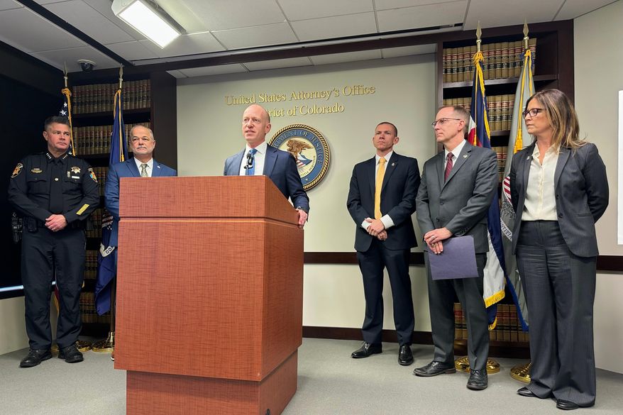 U.S. Attorney for the District of Colorado Peter McNeilly, joined by local and federal officials, announces the indictment of several people accused of working with a Mexican drug trafficking organization, Wednesday, Nov. 19, 2025, in Denver. (AP Photo/Colleen Slevin)