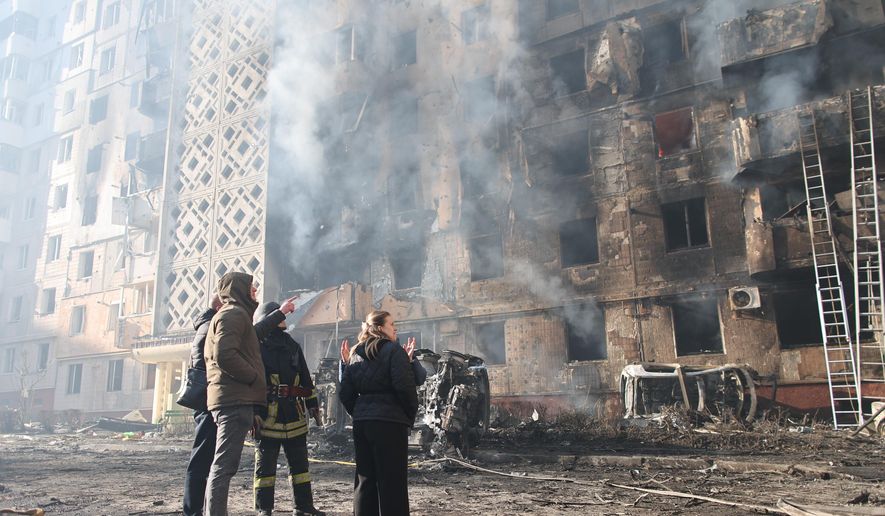 People look at a residential building which was heavily damaged after a Russian strike on Ternopil, Ukraine, on Wednesday, Nov. 19, 2025. (AP Photo/Vlad Kravchuk)