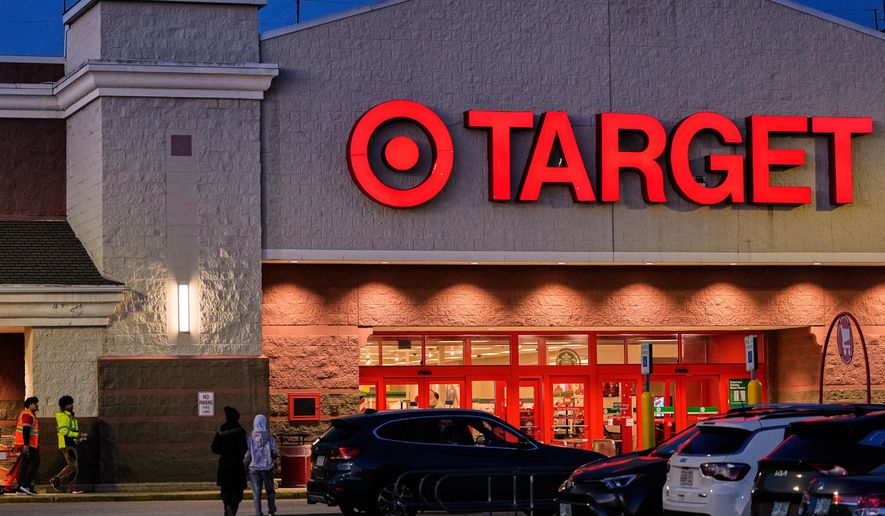 Shoppers walk towards a Target retail store, Tuesday, Nov. 18, 2025, in Salem, N.H. (AP Photo/Charles Krupa)