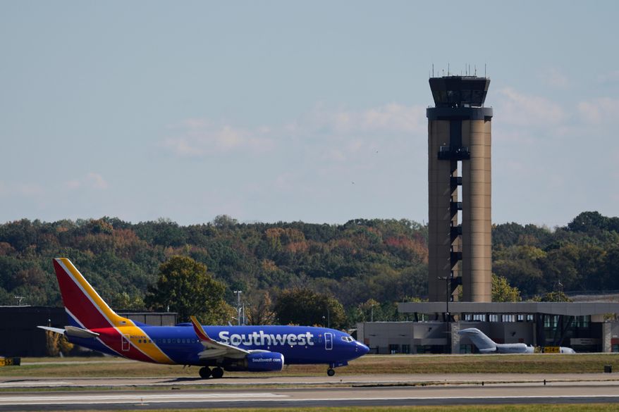 A plane taxis past the control tower before takeoff at the Nashville International Airport, Friday, Oct. 31, 2025, in Nashville, Tenn. (AP Photo/George Walker IV) ** FILE **