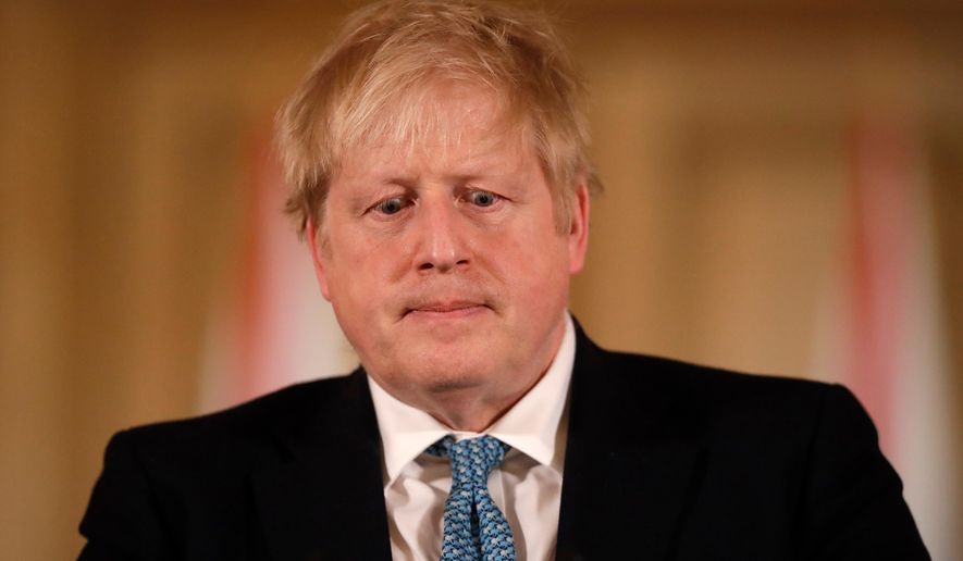 In this March 17, 2020, file photo, then-British Prime Minister Boris Johnson gives a news conference about the ongoing situation with the COVID-19 coronavirus outbreak inside 10 Downing Street in London. (AP Photo/Matt Dunham, Pool)