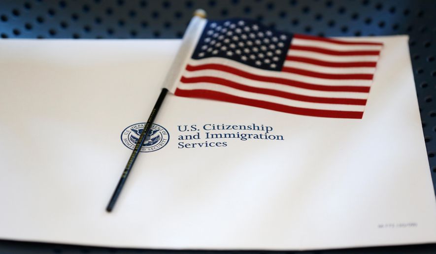 FILE - An information packet and an American flag are placed on a chair at the U.S. Citizenship and Immigration Services Miami Field Office on Aug. 17, 2018, in Miami. (AP Photo/Wilfredo Lee, File)