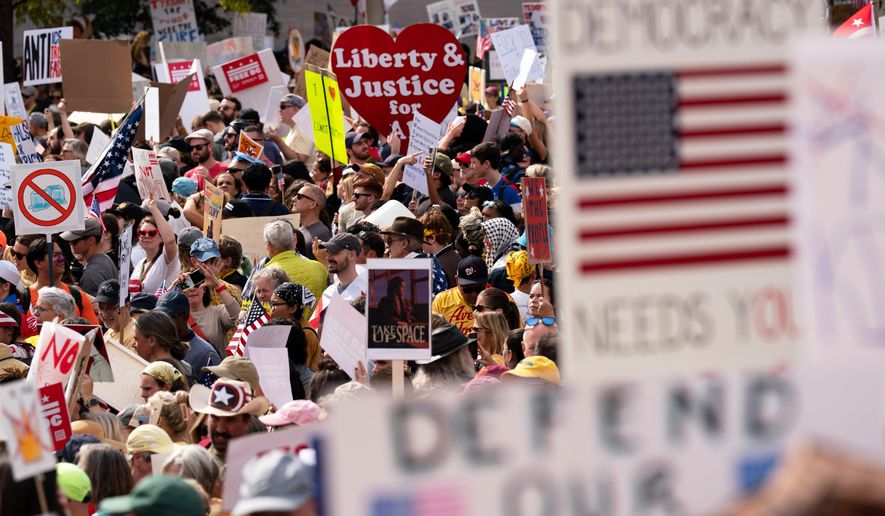 FILE - Demonstrators rally on Pennsylvania Avenue during a No Kings protest in Washington, Oct. 18, 2025. (AP Photo/Jose Luis Magana, File)