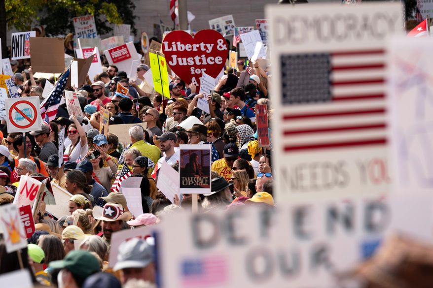 FILE - Demonstrators rally on Pennsylvania Avenue during a No Kings protest in Washington, Oct. 18, 2025. (AP Photo/Jose Luis Magana, File)