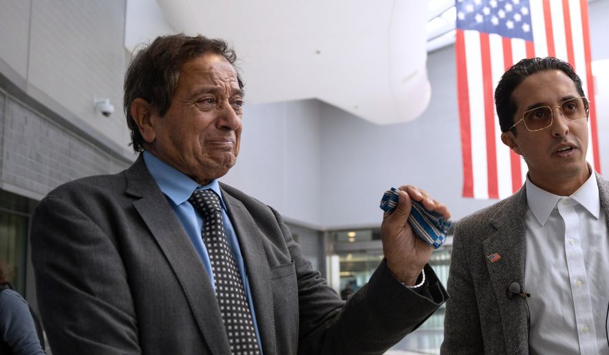 Father-son duo Saad and Ibrahim Almadi speak to reporters after entering the Philadelphia International Airport International Arrivals Hall on Thursday, Nov. 20, 2025, in Philadelphia. (AP Photo/Mingson Lau)