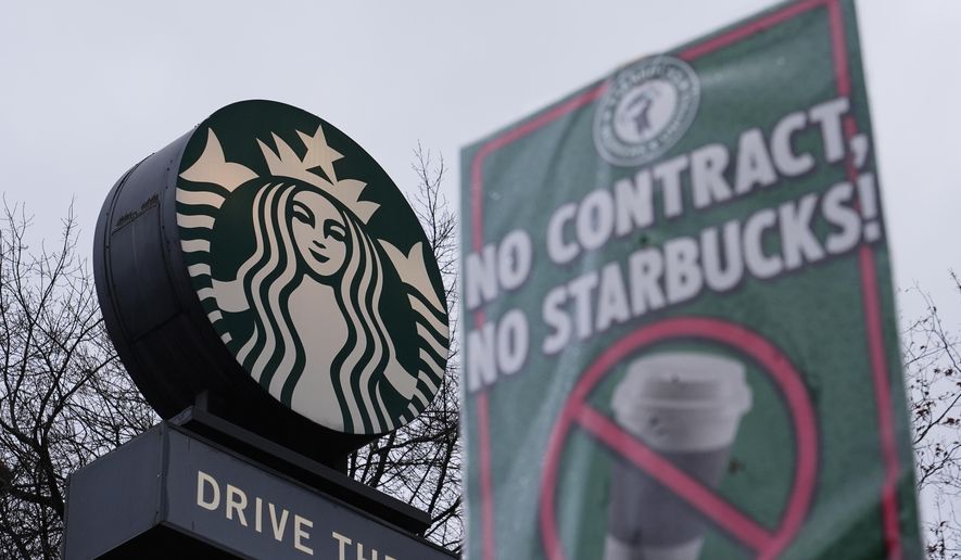 The Starbucks logo is seen as workers strike outside a store Thursday, Nov. 13, 2025, in Seattle. (AP Photo/Lindsey Wasson)