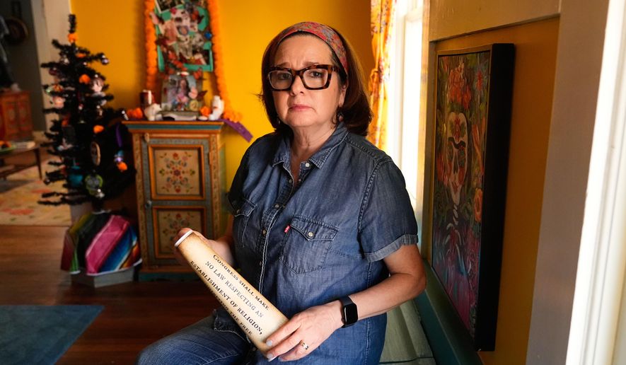 Gigi Cervantes, who resigned from her position as a theater teacher at a Fort Worth school rather than teach in a classroom where the Ten Commandments are hung, poses for a photo at her home, Wednesday, Nov. 5, 2025, in Fort Worth, Texas. (AP Photo/Tony Gutierrez)