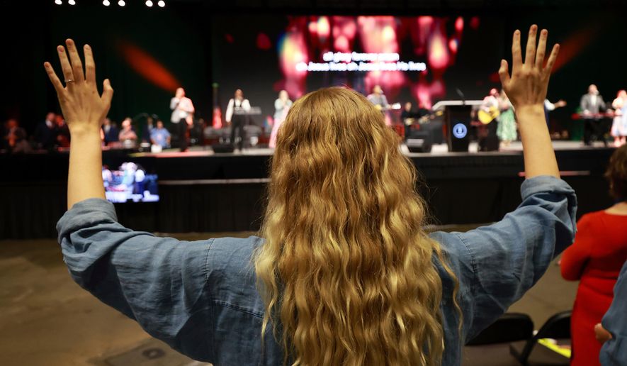 A messenger attending the Southern Baptist Convention participates in worship during the 2025 SBC Annual Meeting, June 10, 2025, in Dallas. (AP Photo/Richard W. Rodriguez, file)