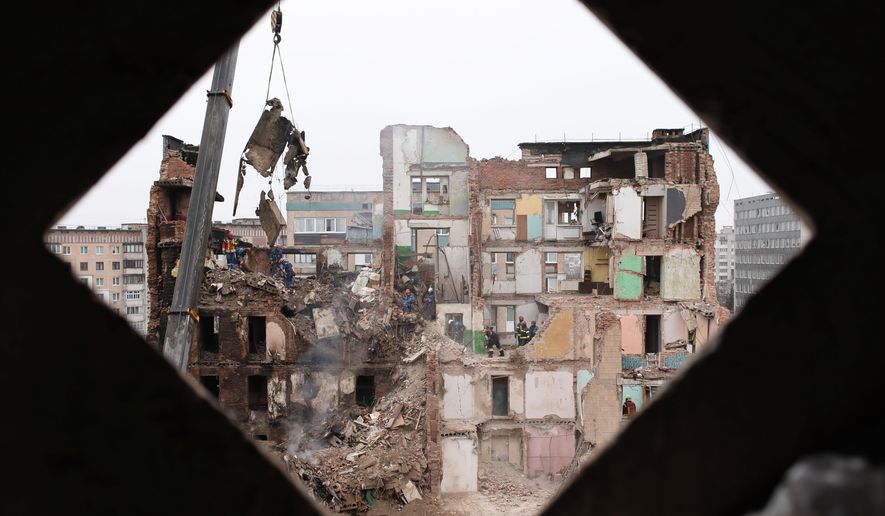 Rescue workers clear the rubble of a residential building which was heavily damaged by a Russian strike on Ternopil, Ukraine, Friday, Nov. 21, 2025. (AP Photo/Vlad Kravchuk)
