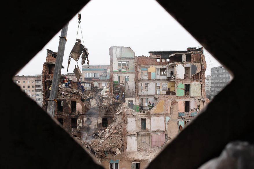 Rescue workers clear the rubble of a residential building which was heavily damaged by a Russian strike on Ternopil, Ukraine, Friday, Nov. 21, 2025. (AP Photo/Vlad Kravchuk)