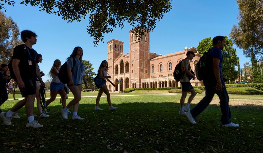 FILE - Students walk past Royce Hall on the UCLA campus in Los Angeles, Aug. 15, 2024. (AP Photo/Damian Dovarganes, File)