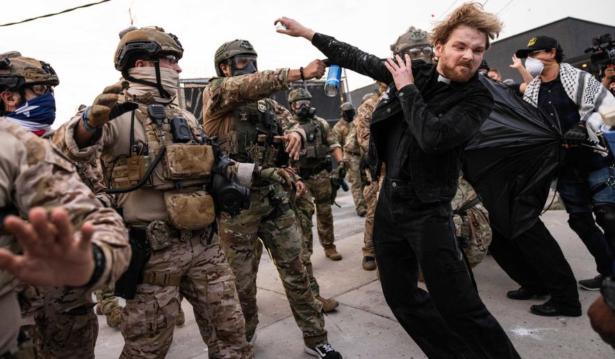 A federal immigration enforcement agent sprays Rev. David Black, of the First Presbyterian Church of Chicago, as he demonstrates outside the U.S. Immigration and Customs Enforcement facility in Broadview, Ill, on Sept. 19, 2025. (Ashlee Rezin/Chicago Sun-Times via AP, File)