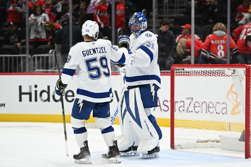 Tampa Bay Lightning goalie Jonas Johansson (31) getting congratulated by Tampa Bay Lightning center Jake Guentzel (59) after the team’s 5-3 win over the Washington Capitals at Capital One Arena in Washington D.C., November 22, 2025. (Photo for the Washington Times)