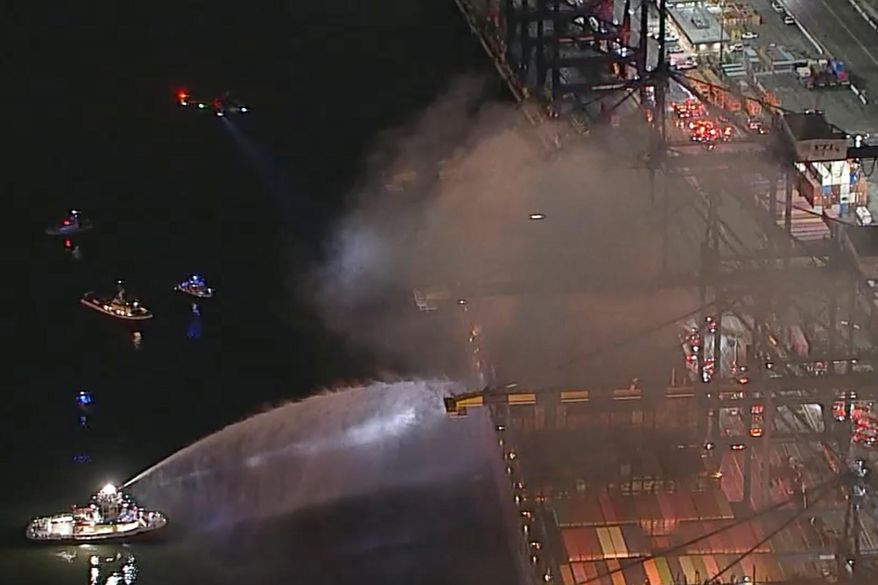 This image taken from video provided by ABC7 shows first responders battling a blaze on a container ship docked at the Port of Los Angeles, Friday, Nov. 21, 2025, in Los Angeles. (ABC7 via AP)