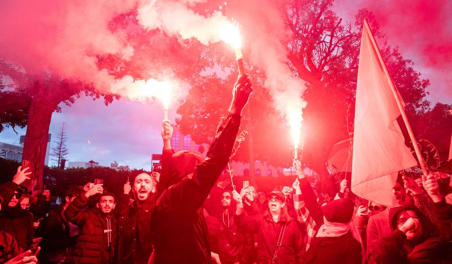 People take part in a protest against Tunisian president Kais Saied's rule and demanding the release of political prisoners in Tunis, Tunisia, Saturday, Nov. 22, 2025. (AP Photo/Anis Mili)