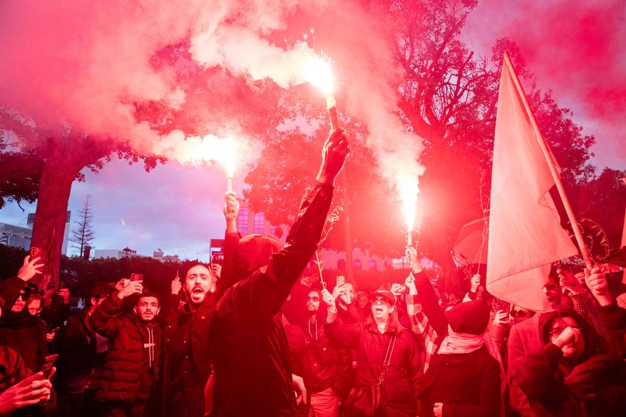 People take part in a protest against Tunisian president Kais Saied's rule and demanding the release of political prisoners in Tunis, Tunisia, Saturday, Nov. 22, 2025. (AP Photo/Anis Mili)