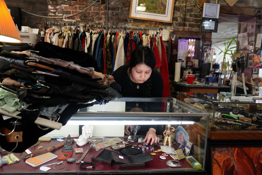 Satani Silva works at Pilsen Vintage, Wednesday, Nov. 19, 2025, in the Pilsen neighborhood of Chicago. (AP Photo/Erin Hooley)