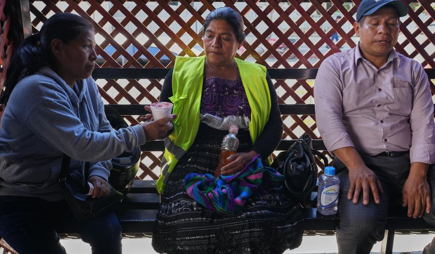 Vilma Pérez, center, the mother of migrant Maria Florinda Ríos Perez who was killed in Indiana, waits for her body outside La Aurora International Airport in Guatemala City, Sunday, Nov. 23, 2025. (AP Photo/Moises Castillo)