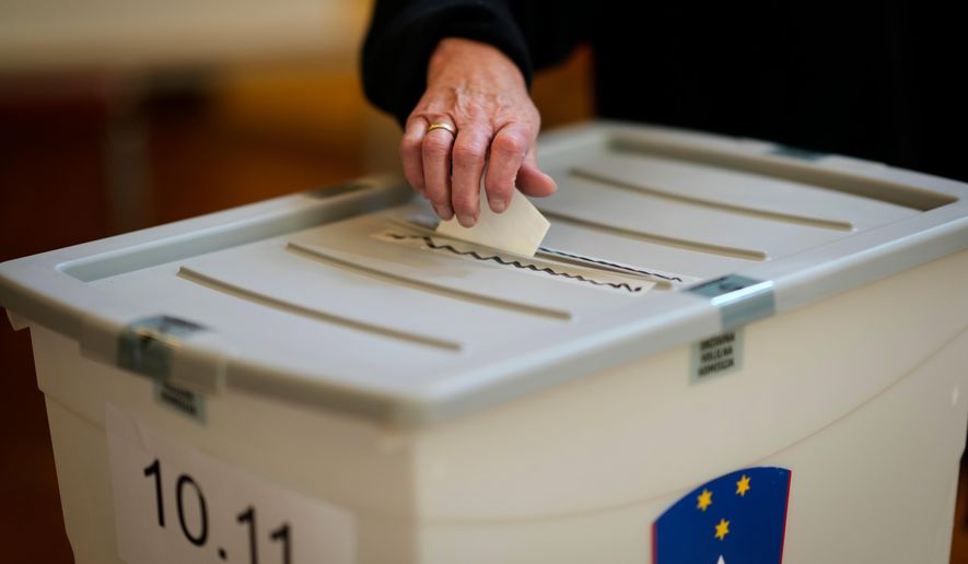 A voter casts her ballot at a polling station during the referendum on assisted dying for terminally ill patients, in Domzale, Slovenia, Sunday, Nov. 23, 2025. (AP Photo/Darko Bandic)