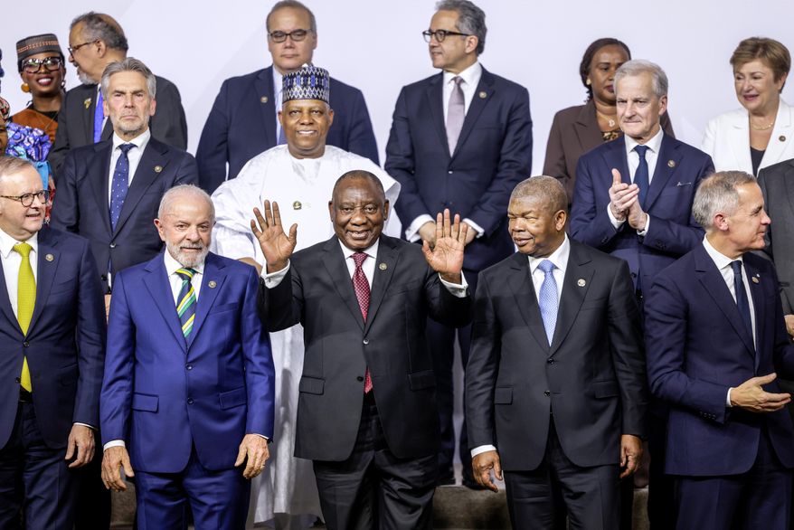 From left, front row, Australia's Prime Minister Anthony Albanese, Brazil's President Luiz Inacio Lula da Silva, South Africa's President Cyril Ramaphosa, President of Angola and Chairperson of the African Union Joao Lourenco and Canada's Prime Minister Mark Carney react as they pose a group photo, on the opening day of the G20 Leaders' Summit, in Johannesburg, South Africa, Saturday, Nov. 22, 2025. (Gianluigi Guercia/Pool Photo via AP)