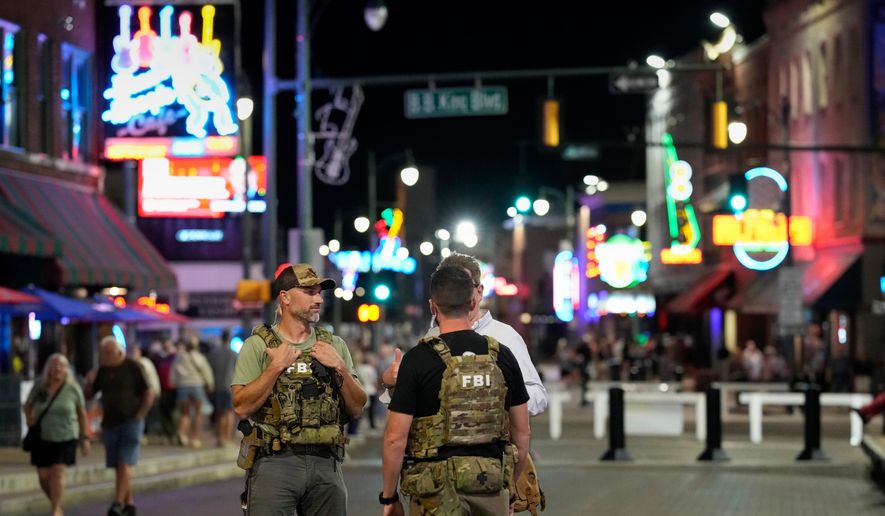 FILE - Federal law enforcement agents walk on Beale Street, Oct. 10, 2025, in Memphis, Tenn. (AP Photo/George Walker IV, File)